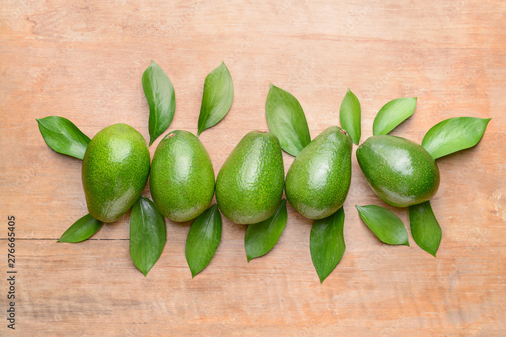 Fresh ripe avocados on wooden background