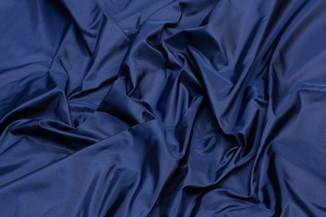 Wall Mural - Silk fabric, satin. The color is blue. Texture, background, pattern.