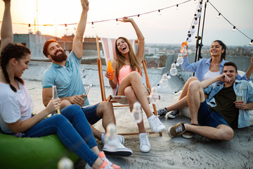 Poster - Friends having party on top of the roof. Fun, summer, city lifestyle and friendship concept