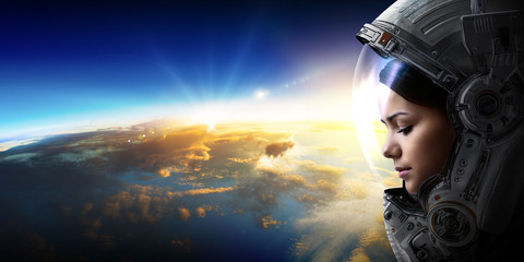 Wall Mural - female astronaut in space on planet orbit.