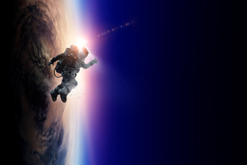 Wall Mural - astronaut in space on planet orbit.