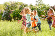 © Andrey - A group of happy children of boys and girls run in the Park on the grass on a Sunny summer day . The concept of ethnic friendship, peace, kindness, childhood