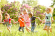 © Andrey - A group of happy children of boys and girls run in the Park on the grass on a Sunny summer day . The concept of ethnic friendship, peace, kindness, childhood