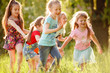 © Andrey - A group of happy children of boys and girls run in the Park on the grass on a Sunny summer day . The concept of ethnic friendship, peace, kindness, childhood