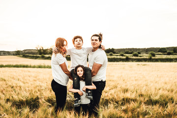 Wall Mural - Portrait of a happy and beautiful family playing in the countryside. Family having fun