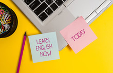 Text Sign Showing Learn English Now. Business Photo Text Gain Or Acquire Knowledge And Skill Of English Language Trendy Metallic Laptop Sticky Notes Clips Container Pencil Colored Background
