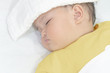 © StockerThings - Sick baby girl sleeping with white towel at head reducing temperature