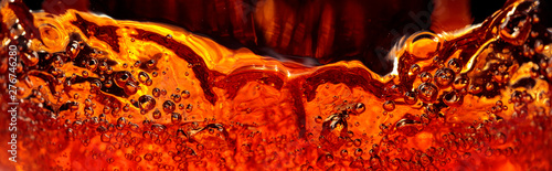 Alcoholic drink on a dark background, abstract splashing. Poster Mural XXL