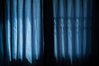 Blue curtain at window, Halloween day in night on room with horror window, Copy space.