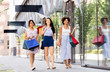 © Syda Productions - sale, consumerism and people concept - happy young women with shopping bags walking along city street