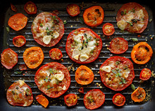 Grilled Tomato Slices With Mozzarella Cheese, Garlic, Herbs And Spices On The Grill Plate, Top View. Vegetarian Grilled Food