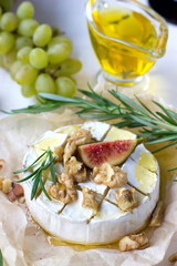 Wall Mural - Baked Camembert with nuts, honey, figs, rosemary, top view