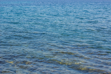 Wall Mural - slightly wavy water natural background surface near shoreline 