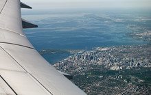 Aerial View Of Toronto Downtown Highrise Buildings And West Edge Of Lake Ontario With Curved Airplane Wing Canada