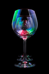 Party wine glasses lit by red, green, blue nightclub lights, nightlife and entertainment industry, objects in row isolated on black background