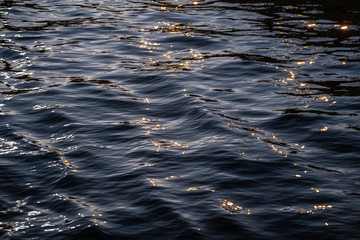 water surface with reflections in the evening. Abstraction.