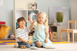 © Pixel-Shot - Cute little children playing in kindergarten