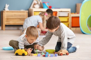 Sticker - Cute little children playing in kindergarten