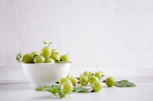 Bowl Full Of Ripe Fresh Gooseberries On The White Table Against White Background