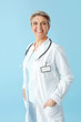 © Pixel-Shot - Mature female doctor on color background