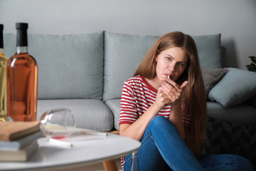 Poster - Young woman with addiction to alcohol and cigarettes relaxing at home