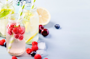 Sticker - Summer drinks set. Berry, fruit and citrus non-alcoholic refreshing ice cold beverages and cocktails in glass bottles on blue background