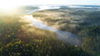 © raland - Aerial shot of foggy autumn morning at lake. Beautiful forest and sun rays.