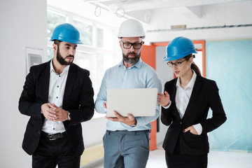 Engineers in hardhats have conversation