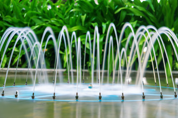 Beautiful fountain on the background of tropical plants. Garden decoration, spa, hotel. landscape design