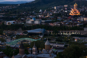 Poster - sunset over tbilisi with illuminated peace bridge