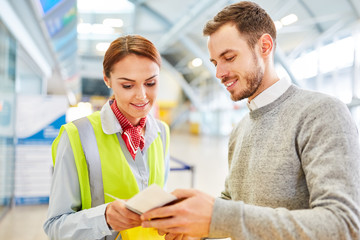 Canvas Print - Service clerk at the airport Check-in controlled passport