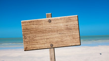 Blank Rustic Wooden Sign On The Beach