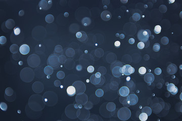 abstract sparkle bokeh light effect with navy blue background