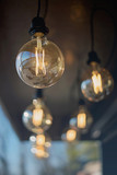 Fototapeta Boho - Loft round light bulbs on black wires