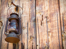Rusted Vintage Oil Lantern Hanging Outside Barn Above Old Horseshoe In Horizontal