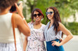 © Syda Productions - female friendship, technology and people - woman with camera photographing her friends in summer park