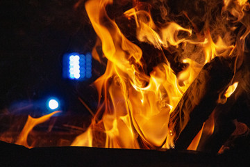 Campfire with a light in the background