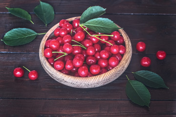 cherry berries in a wooden bowl close-up. background with ripe cherry berries.