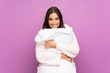 © luismolinero - Young woman in pajamas and dressing gown over isolated purple background