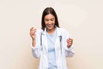 Young doctor woman over isolated background laughing