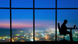 © realstock1 - The silhouette of working man near window on the night city background