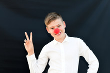 The Young Smiling Guy On Red Nose Day Charity And Childhood Concept. Clown, Fun, Party, Celebration, Funny, Joy, Holiday, Humor Concept.