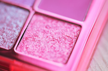 Wall Mural - Pink glitter eye shadow closeup. Bright make up product.