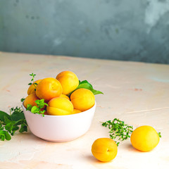 Wall Mural - Fresh sweet orange apricots in pink bowl