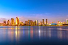 Panoramic Landscape Of San Diego Skyline With Illuminated Skyscrapers Reflecting In San Diego Bay At Twilight. Districts Of Waterfront Marina Skyline And Urban Downtown Cityscape At Sunset Light.