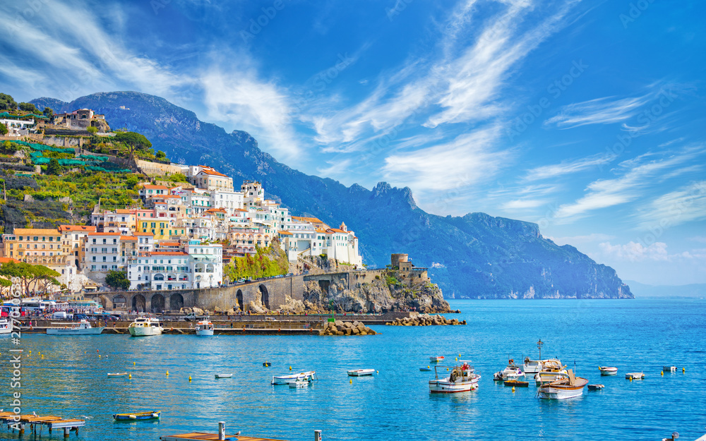 Beautiful Amalfi on hills leading down to coast, comfortable beaches and azure sea on Amalfi Coast in Campania, Italy - obrazy, fototapety, plakaty 