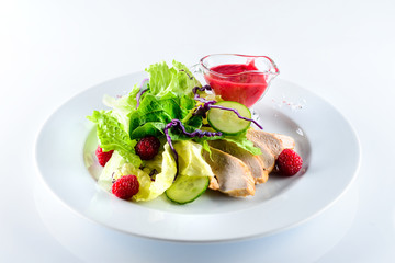 Canvas Print - salad with chicken fillet and fresh berries on a light background