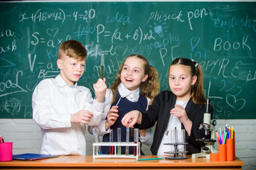 Fascinating chemistry. Group school pupils study chemistry in school. Boy and girls enjoy chemical experiment. Organic chemistry is study of compounds containing carbon. Basic chemical reactions