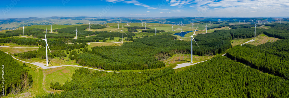 Aerial drone panorama of turbines at a large onshore windfarm in Wales, UK - obrazy, fototapety, plakaty 