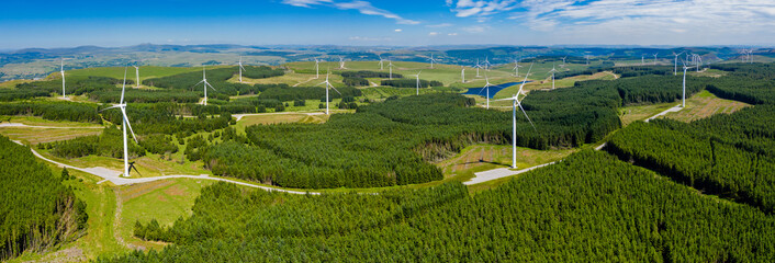 Wall Mural - Aerial drone panorama of turbines at a large onshore windfarm in Wales, UK